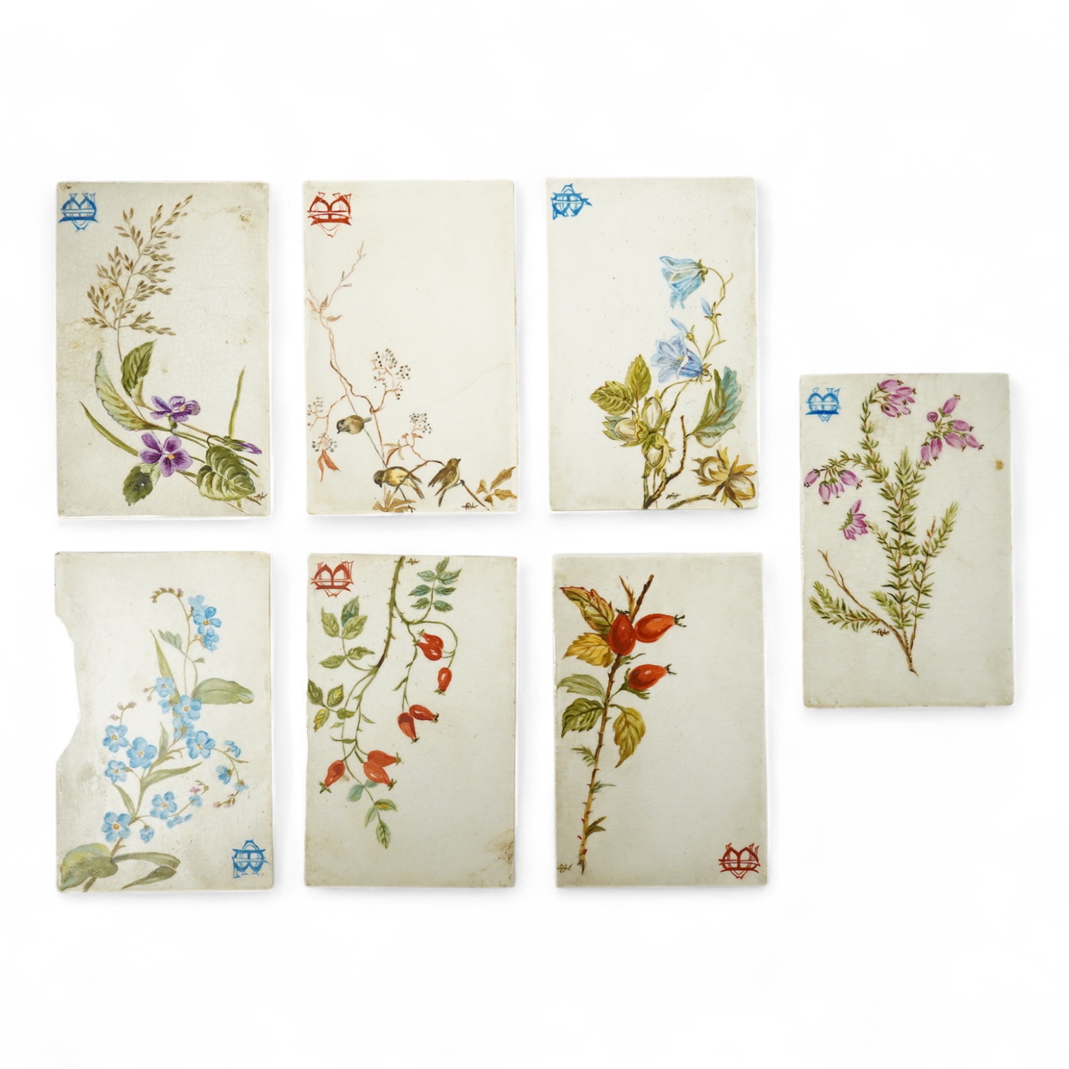 Set of seven late 19th century miniature floral painted pottery plaques, each monogramed 8.5cm high, possibly for place settings